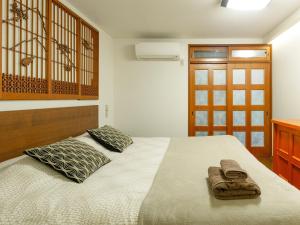 Postel nebo postele na pokoji v ubytování Yukari Shijo Kyoto