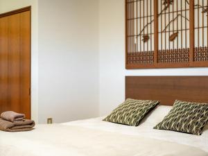 Postel nebo postele na pokoji v ubytování Yukari Shijo Kyoto