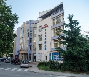 a building with a car parked in front of it at Flagman Hotel in Sozopol