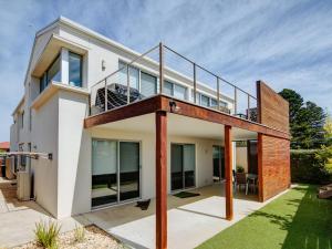 a house with a deck and a balcony at Villa Moyne in Port Fairy