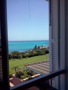 a view of the ocean from a window at Rocca Ruja Vip in Stintino