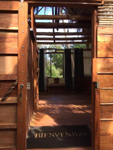 an open door to a barn with a sign that says herrington at Iguanitas Lodge in Pital