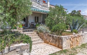 a house with a stone retaining wall and stairs at 1 Bedroom Gorgeous Apartment In Pavicini in Pavicini