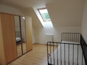 a bedroom with a bunk bed and a window at Apartmánový Dom River in Blatnica