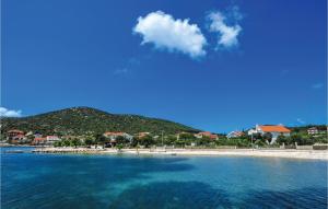 a view of a beach with a mountain in the background at Beautiful Apartment In Vinisce With 1 Bedrooms And Wifi in Vinišće