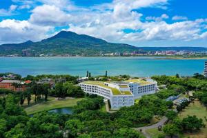 an aerial view of a hotel and the water at Golden Tulip FAB Hotel New Taipei in Tamsui