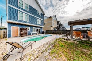 a backyard with a swimming pool and a house at Sweet Retreat in Nags Head in Nags Head