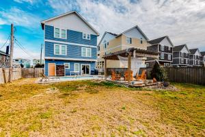 a large blue house with a yard at Sweet Retreat in Nags Head in Nags Head