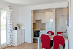 een keuken met rode stoelen en een tafel in een kamer bij Beach Stay Apartment Ivon in Ivan Dolac