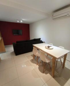 a living room with a table and a couch at Departamentos Kairos H in Mendoza
