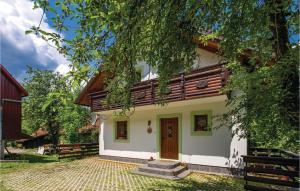 an exterior view of a house with a tree at Awesome Home In Brod Na Kupi With Sauna in Brod na Kupi +51 photos