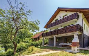 a house with a balcony on the side of it at Awesome Home In Brod Na Kupi With Sauna in Brod na Kupi
