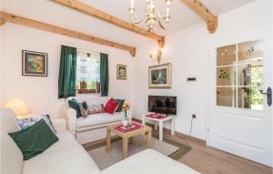 a living room with a white couch and a table at Awesome Home In Brod Na Kupi With Sauna in Brod na Kupi