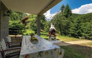 a table on a porch with a bird house at Awesome Home In Brod Na Kupi With Sauna in Brod na Kupi