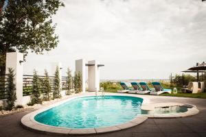a swimming pool with lounge chairs around it at El Locanda Boutique Hotel in Constanţa
