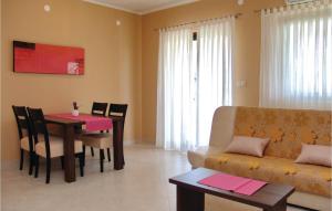 a living room with a table and a couch at Pet Friendly Apartment In Porec With Wifi in Poreč