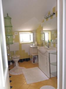 a bathroom with a sink and a toilet at Apartments Vanda in Vrboska