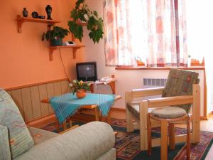 a living room with a couch and a table at Pensjonat Lotos in Krynica Morska
