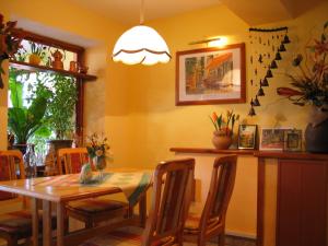 a dining room with a table and chairs at Pensjonat Lotos in Krynica Morska +17 photos