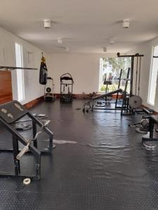 a gym with several treadmills and equipment in a room at Departamento Planta Baja con parqueo en Condominio in Santa Cruz de la Sierra
