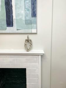 a fireplace with a heart ornament on top of it at Wrigleyville Friends Unit - 5bdrm in Chicago