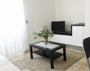 TV a/nebo společenská místnost v ubytování Le Casette