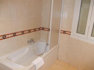 a bathroom with a shower and a tub and a sink at Hotel Marcellin in Beaulieu-sur-Mer