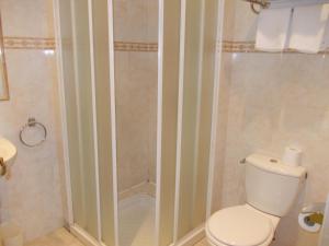 a bathroom with a toilet and a shower at Hotel Marcellin in Beaulieu-sur-Mer