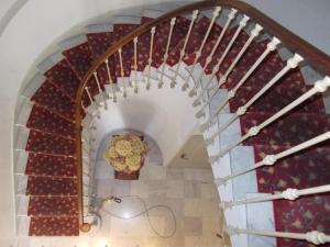 a spiral staircase with a vase of flowers at Hotel Marcellin in Beaulieu-sur-Mer