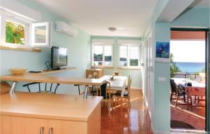a kitchen with a table and a dining room with the ocean at 4 Bedroom Nice Apartment In Drvenik Mali in Velike Kuknjare