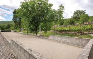 a stone wall with a street light on top of it at Two-Bedroom Holiday Home In Slivno in Slivno +12 photos