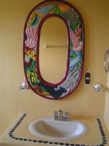 a bathroom with a sink and a mirror at Hotel Paradise Lagoon in El Coacoyul