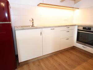 a kitchen with white cabinets and a sink at Exquisite vacation apartment in Mittersill near ski area in Mittersill