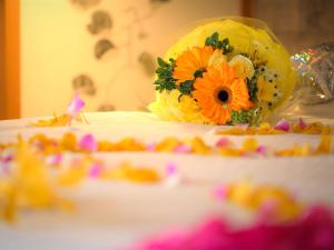 a cake with flowers on top of a table at 鸛巣（ムカカヴィラ コウノス) in Nakijin +15 photos