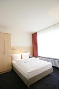Postel nebo postele na pokoji v ubytování Hotel Senator München