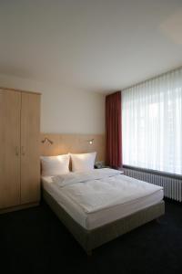 Postel nebo postele na pokoji v ubytování Hotel Senator München