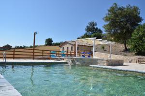 a pool of water with a table and chairs in it at Agriturismo Fontefredda in Tavenna