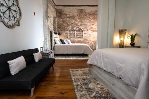 a living room with two beds and a couch at French Quarter Q in New Orleans