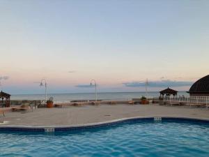 a large swimming pool with a view of the ocean at Atlantic Palace in Atlantic City