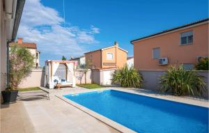 a swimming pool in the backyard of a house at Beautiful Home In Pula in Pula +39 photos