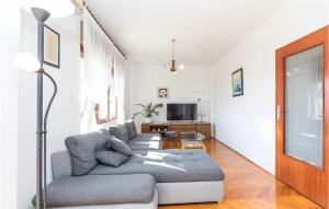 a living room with a couch and a tv at Beautiful Apartment In Trogir With Wifi in Trogir