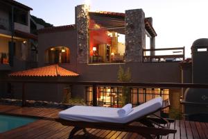 a mattress sitting on a deck next to a swimming pool at Kkala Boutique Hotel in Salta