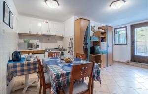 a kitchen with a table and chairs in a kitchen at Pet Friendly Apartment In Pavicini With Wifi in Pavicini