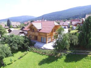 a large wooden house in the middle of a field at Modern chalet with garden in Salzburgerland near the Katschberg ski area in Sankt Margarethen im Lungau