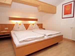 a bedroom with a bed with white sheets and pillows at Apartment in Embach Austria near ski area in Embach