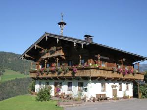 a large house with flowers on the balcony at Apartment in Embach Austria near ski area in Embach