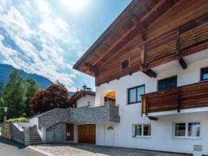 a house with a wooden roof at Apartment near the Hahnenkamm cable car in Kitzbühel