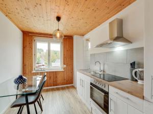 a kitchen with a table and a glass counter top at Apartment in St Lambrecht near ski area in Sankt Lambrecht