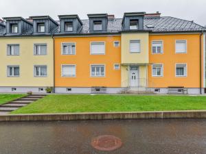 an orange and yellow building with grass in front of it at Apartment in St Lambrecht near ski area in Sankt Lambrecht