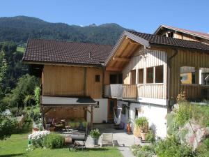 a house with a porch and a balcony with a patio at Apartment with view of Schruns in Schruns-Tschagguns